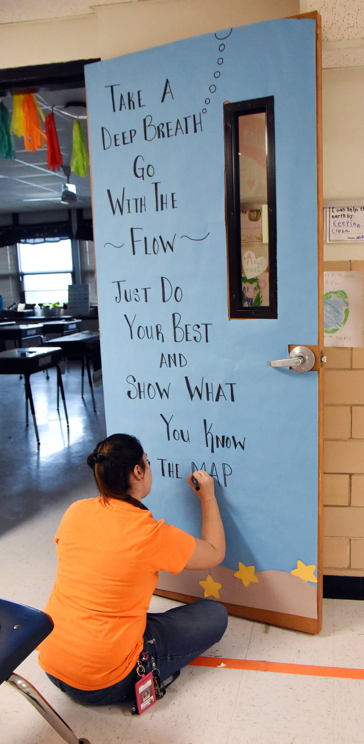 Gerald Elementary School fifth-grade teacher Olivia Reiker finishes a door covering Monday ahead of upcoming MAP testing which encourages her students to “go with the flow” and not worry about the process.